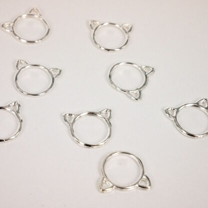 Silver stitch markers with cat ears.